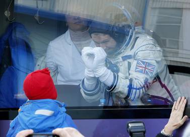 British astronaut Tim Peake, a member of the main crew of the expedition to the International Space Station (ISS), gestures to his child from a bus prior the launch of Soyuz TMA-19M space ship at the Russian-leased Baikonur cosmodrome, Kazakhstan. Dmitry Lovetsky / AP Photo
