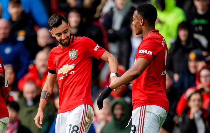 Manchester United's Bruno Fernandes, left, celebrates with Anthony Martial after scoring against Watford. EPA