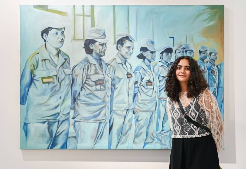 Artist Amina Yahia with her work 'Ya Aghla Ism Fi El Wogood'.