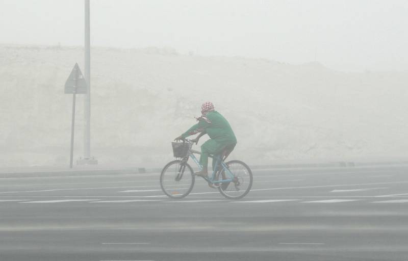 DUBAI, UNITED ARAB EMIRATES , July 21 – 2020 :- A cyclist during the sandstorm in Discovery Gardens area in Dubai.  (Pawan Singh / The National) For News/Standalone/Online/Stock