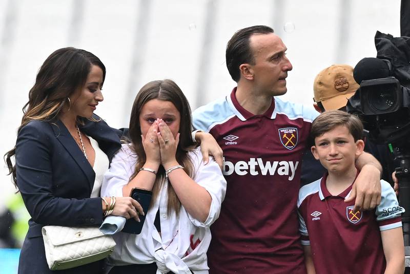 West Ham's English midfielder Mark Noble with his family at the London Stadium. AFP
