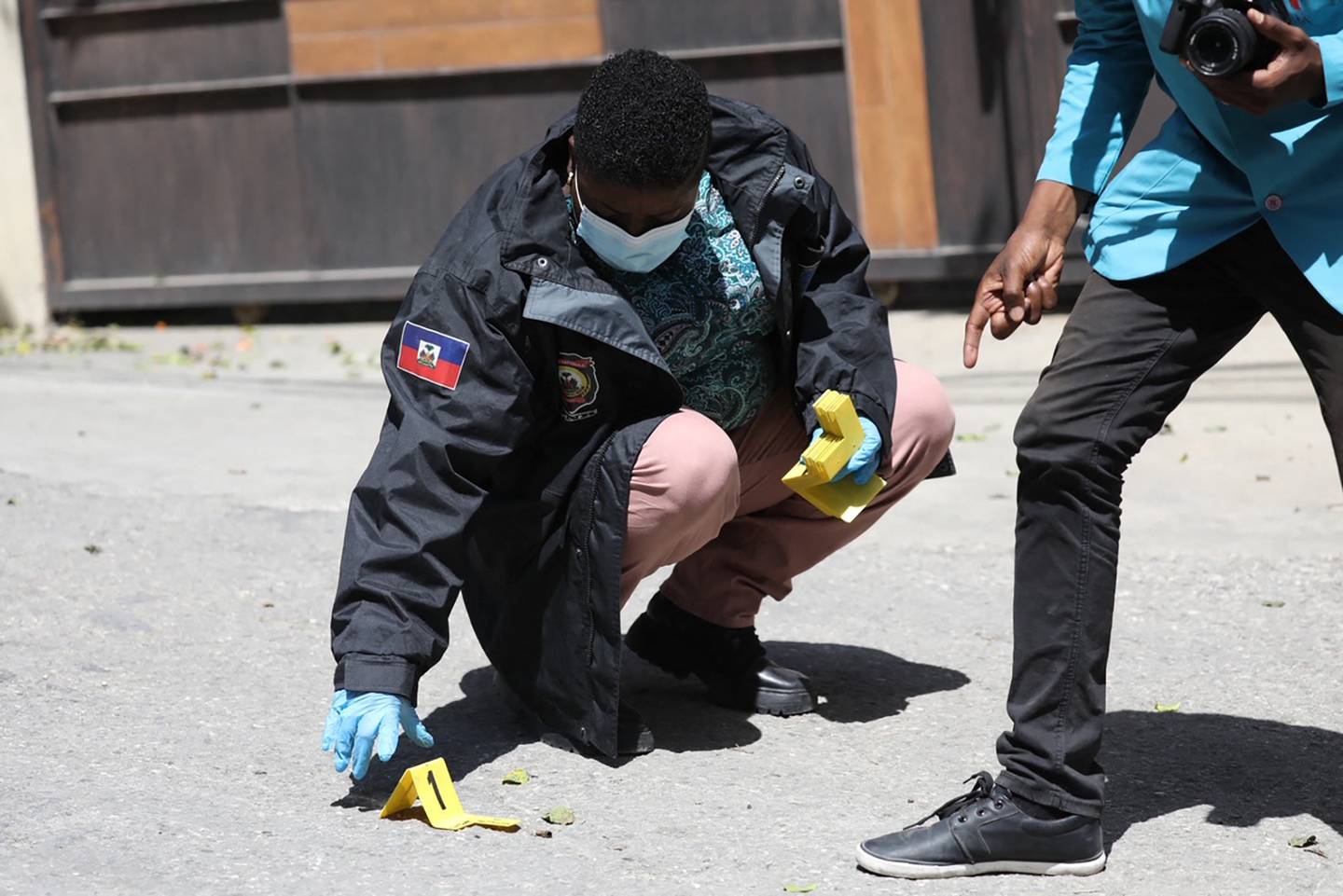 Members of the Haitian police and forensics look for evidence outside the presidential residence in Port-au-Prince. AFP 