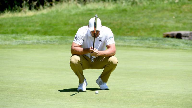 Bryson DeChambeau lines up his putt on the third hole. AFP
