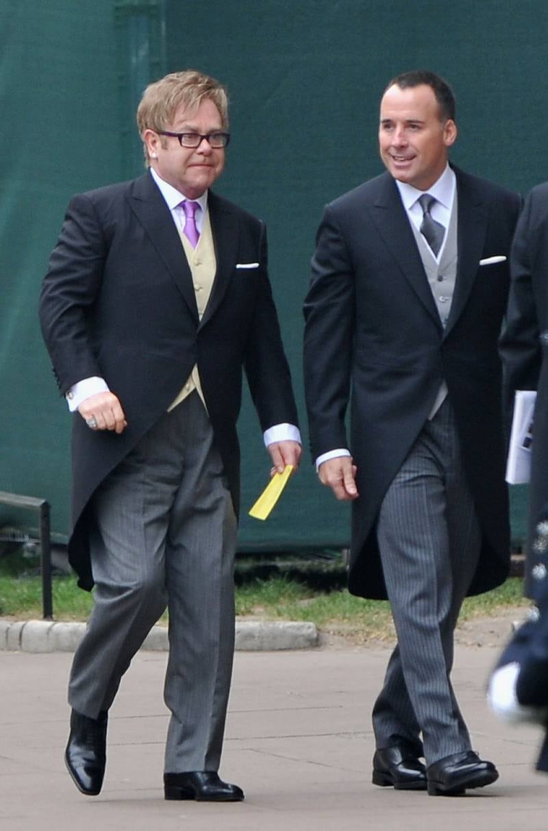 Elton John, in a morning suit with a yellow waistcoat, and David Furnish attend the wedding of Prince William and Catherine Middleton at Westminster Abbey, London on April 29, 2011. Getty Images