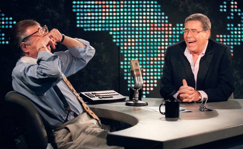 Larry King wipes his eyes after laughing at a joke by comedy legend Jerry Lewis during an interview on August 26, 1999. AP Photo