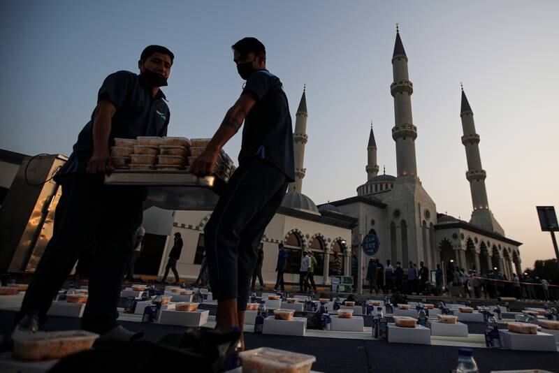 Mosque staff arrange food items before sunset outside Al Farooq Mosque in Dubai. Lessons learnt during Ramadan can also be applied to people's finances. EPA