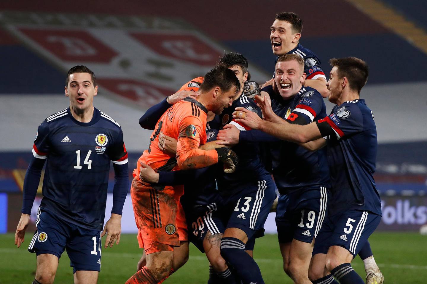 BELGRADE, SERBIA - NOVEMBER 12: David Marshall of Scotland celebrates with Leigh Griffiths of Scotland and Scott McTominay of Scotland and his team as they celebrate after their victory in the UEFA EURO 2020 Play-Off Final between Serbia and Scotland at Rajko Mitic Stadium on November 12, 2020 in Belgrade, Serbia. Football Stadiums around Europe remain empty due to the Coronavirus Pandemic as Government social distancing laws prohibit fans inside venues resulting in fixtures being played behind closed doors. (Photo by Srdjan Stevanovic/Getty Images)