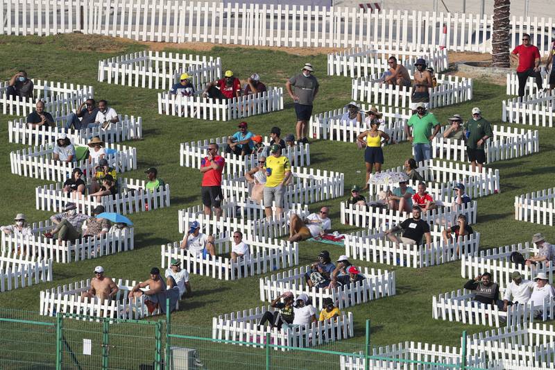 Spectators watch from fenced pens the Cricket Twenty20 World Cup match between South Africa and Australia in Abu Dhabi, UAE, Saturday, Oct.  23, 2021.  (AP Photo / Kamran Jebreili)