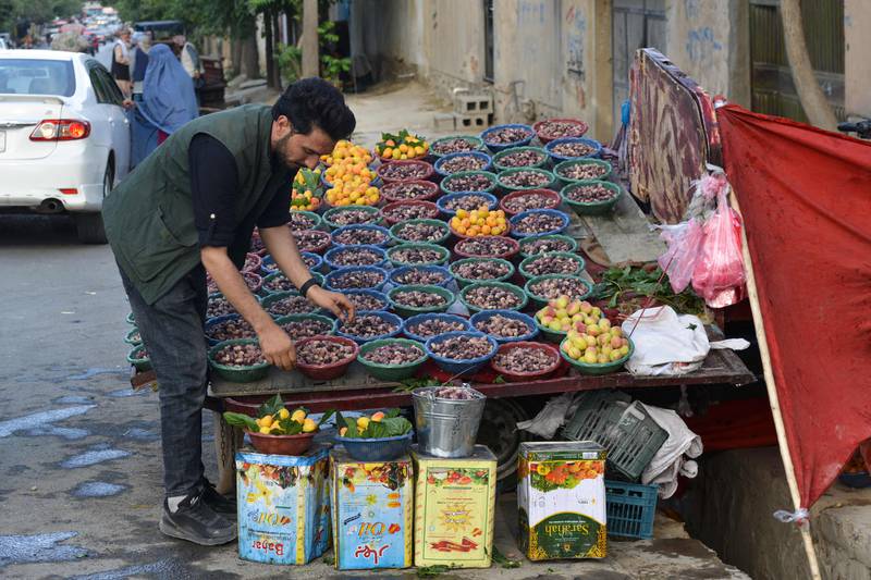A man sells freshly picked berries in Kabul, Afghanistan, one of the countries spending at least a tenth of its export revenue to pay off rising debts. Nearly 75 countries, including Afghanistan, Ghana, Yemen and Ethiopia, are eligible to receive IDA resources. AFP