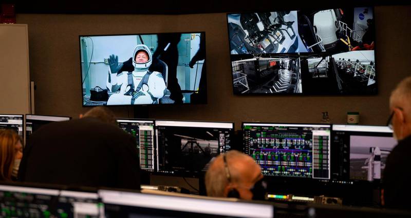 Astronaut Douglas Hurley is seen on a monitor in firing room four during suit-up at the Neil A Armstrong Operations and Checkout Building ahead of the planned launch.  AFP