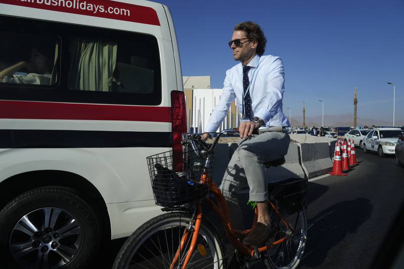 A member of the Dutch delegation cycles to Cop27.  AP Photo