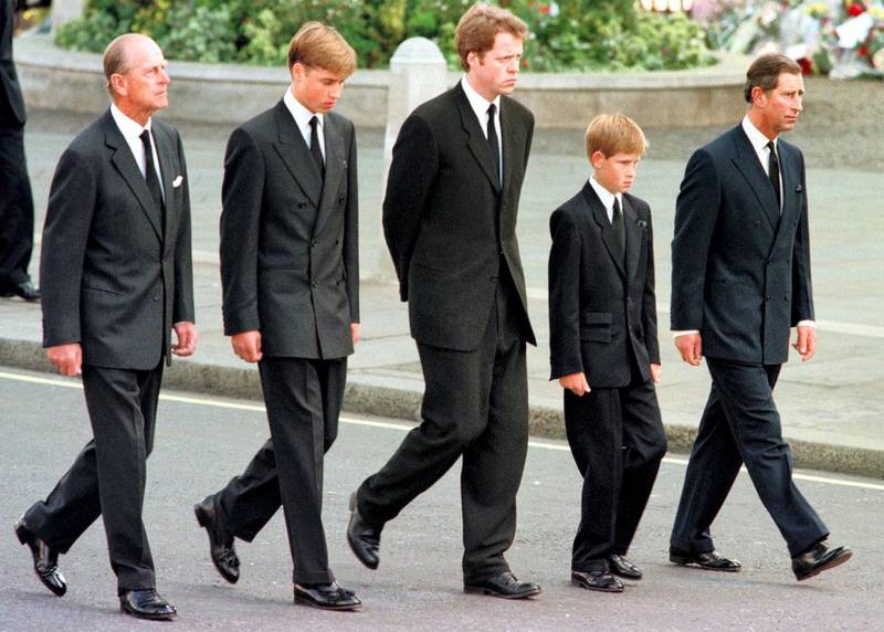 (L to R) The Duke of Edinburgh, Prince William, Earl Spencer, Prince Harry and Prince Charles walk outside Westminster Abbey during the funeral service for Diana, Princess of Wales, 06 September. Hundreds of thousands of mourners lined the streets of Central London to watch the funeral procession. The Princess died last week in a car crash in Paris. / AFP PHOTO / RTR/WPA POOL / JEFF J. MITCHELL
