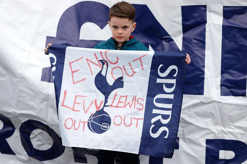 A young Tottenham fan holds up a sign. Reuters