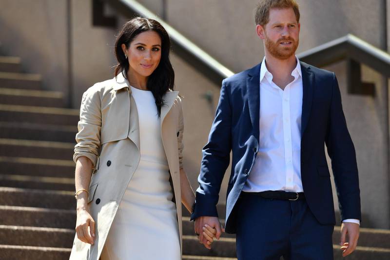 (FILES) In this file photo taken on October 16, 2018 Britain's Prince Harry and his wife Meghan walk down the stairs of Sydney’s iconic Opera House   A judge will issue a ruling on Meghan Markle's privacy claim against a newspaper group for publishing a private letter she wrote to her estranged father on February 11, 2021. / AFP / SAEED KHAN
