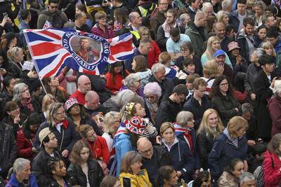 Well-wishers line the route of the coronation procession. AP