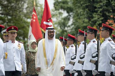 SINGAPORE, SINGAPORE - February 28, 2019: HH Sheikh Mohamed bin Zayed Al Nahyan, Crown Prince of Abu Dhabi and Deputy Supreme Commander of the UAE Armed Forces (C), inspects the honour guard during a reception hosted by HE Halimah Yacob, President of Singapore, (back 3rd L), during a reception at the Istana presidential palace.
( Ryan Carter / Ministry of Presidential Affairs )