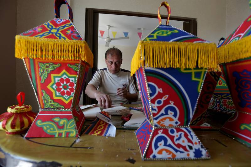 A Palestinian man makes lanterns for sale in preparation for the Muslim holy month of Ramadan, as he confines himself with his family to their home amid concerns about the spread of the coronavirus, in the southern Gaza Strip on April 14, 2020. Reuters