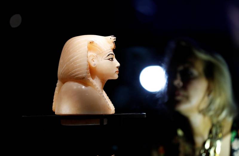 A woman looks at alabaster King's Head during the media preview of "Tutankhamun: Treasures of the Golden Pharaoh" exhibition set to open at the Saatchi Gallery in London, Britain November 1, 2019. Reuters