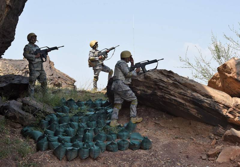 (FILES) In this file photo taken on October 03, 2017 Saudi border guards keep watch along the border with Yemen in the al-Khubah area in the southern Jizan province. A projectile attack sparked a fire at an oil terminal in southern Saudi Arabia, the country's energy ministry said on March 25, 2021, on the sixth anniversary of a Riyadh-led military intervention in Yemen. The ministry did not say who was behind the strike in Jizan province, but it comes as Yemen's Huthi rebels escalate attacks on the kingdom -- including its energy facilities -- despite Saudi Arabia's offer this week for a ceasefire.
 / AFP / Fayez Nureldine
