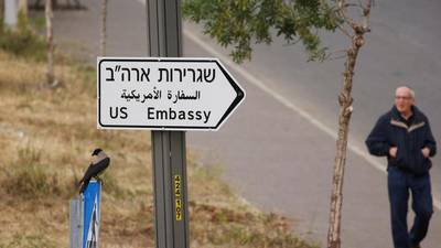 A man walks next to a road sign directing to the US embassy, in the area of the US consulate in Jerusalem, May 7, 2018. Reuters