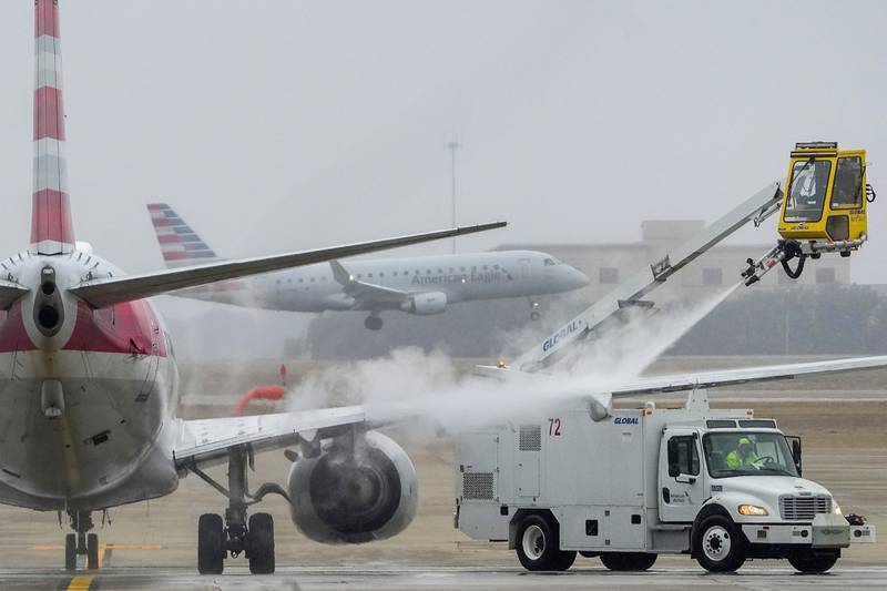 Ice is blasted from an American Airlines plane at Dallas/Fort Worth International Airport in Texas. The Dallas Morning News / AP