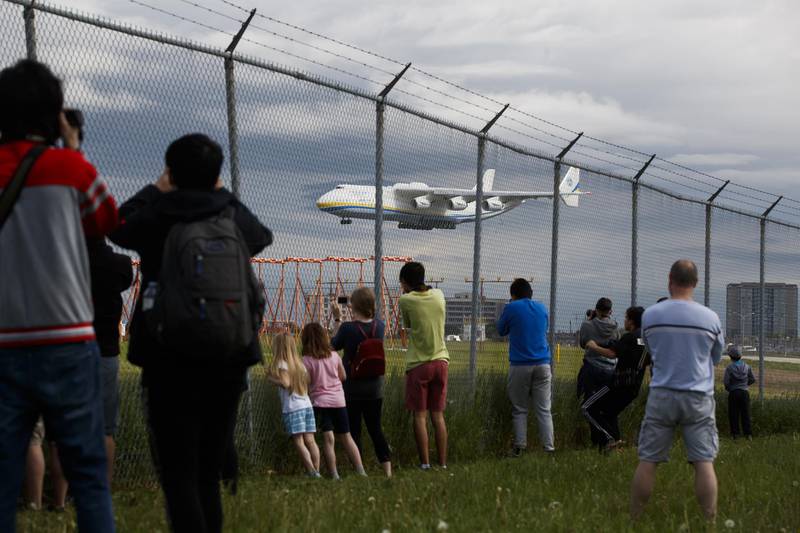 People watch as the Antonov AN-225 Mriya aircraft lands in Toronto. Bloomberg