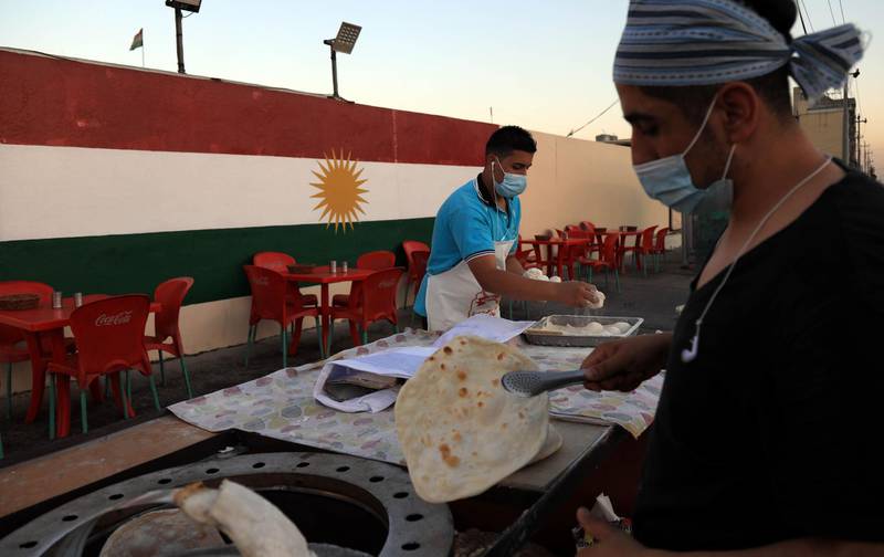 Iraqi Kuridish men prepare bread in Arbil, the capital of the autonomous Kurdish region of northern Iraq. AFP