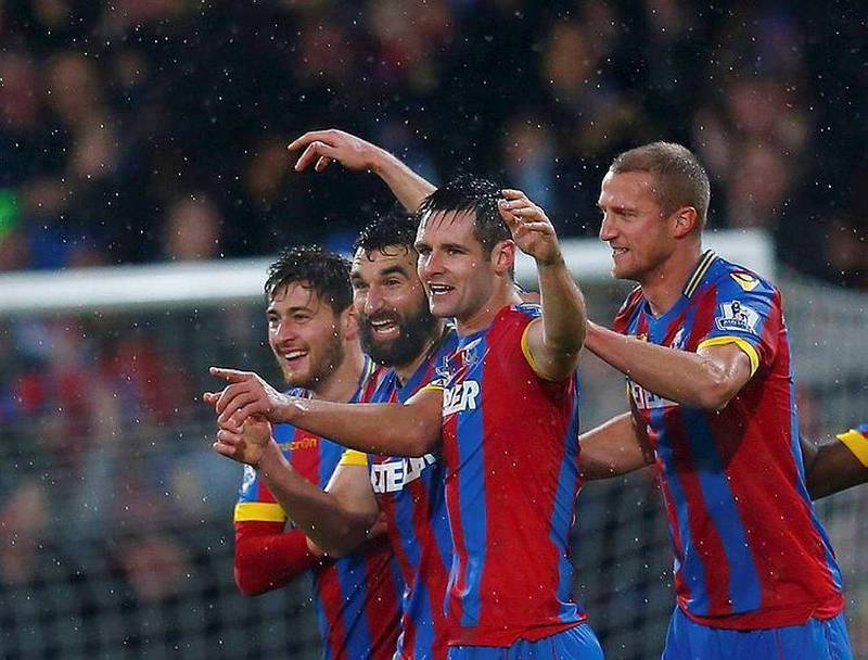 Mile Jedinak, second from left, celebrates with his teammates after setting up a memorable win at Selhurst Park. Eddie Keogh / Reuters