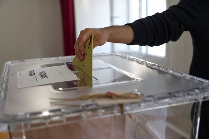 A voter casts a ballot at a polling station in Hatay. Reuters