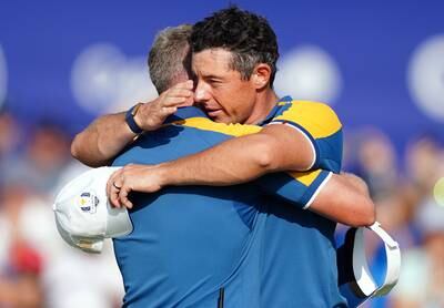 Team Europe's Rory McIlroy with captain Luke Donald following his singles match on day three. PA