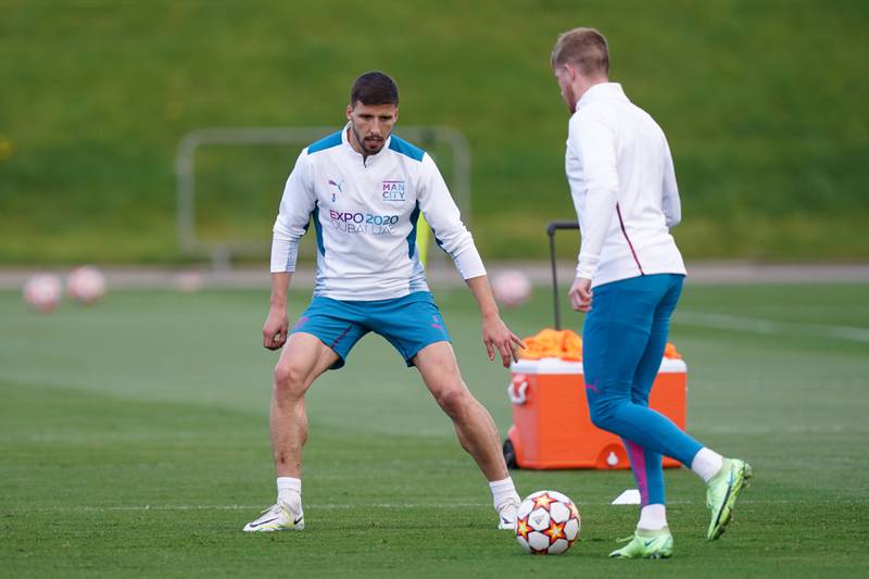Ruben Dias, left, and Kevin De Bruyne during a training session at the City Football Academy in Manchester. PA