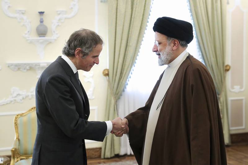Iranian President Ebrahim Raisi shakes hands with International Atomic Energy Organisation Director General Rafael Grossi in Tehran earlier in the month. AP Photo