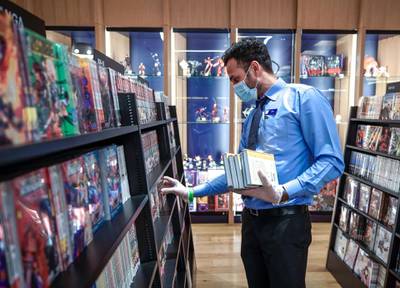 Abu Dhabi, United Arab Emirates, May 10, 2020.  A Kinokuniya book shop worker arranges some books at the Galleria Mall, Al Maryah Island, Abu Dhabi.Victor Besa/The NationalSection:  NAReporter: