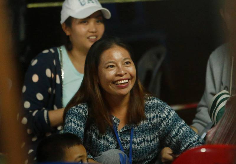 A family member smiles after hearing the news that the  missing 12 boys and their soccer coach have been found, in Mae Sai, Chiang Rai province, in northern Thailand, on July 2, 2018. Sakchai Lalit / AP Photo