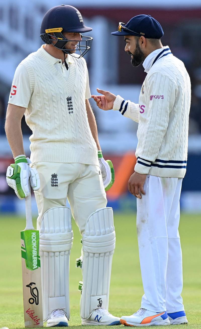 England's Jos Buttler talks to India's captain Virat Kohli on the fifth and final day of the second Test match at Lord's.