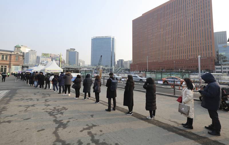 People queue for coronavirus tests in Seoul on February 26, as South Korea grapples with a surge in infections driven by the Omicron variant. Yonhap via AP