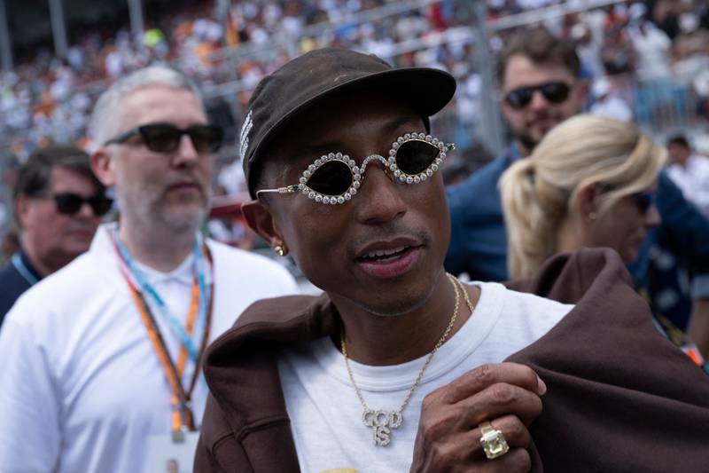 Musician Pharrell Williams walks on the grid before the Miami Grand Prix. AFP