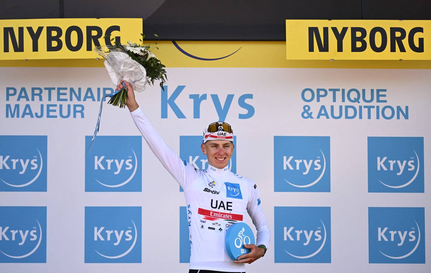 UAE Team Emirates' Slovenian rider Tadej Pogacar celebrates on the podium with the best young rider jersey after the second stage of the Tour de France on July 2, 2022. AFP