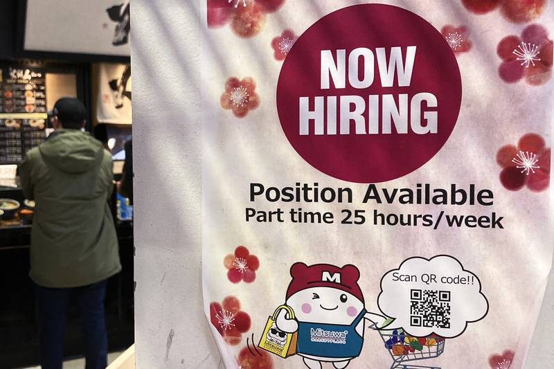 A hiring sign at a grocery store in Arlington Heights, Illinois. The pace of hiring in the US is showing surprising resilience in the face of higher interest rates across the economy, at least for now. AP