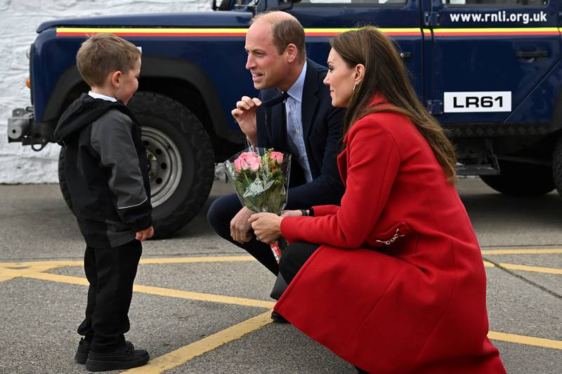 Prince William and his wife Kate receive flowers from four-year-old Theo Crompton during their visit to the RNLI Holyhead Lifeboat Station in Wales. Getty Images