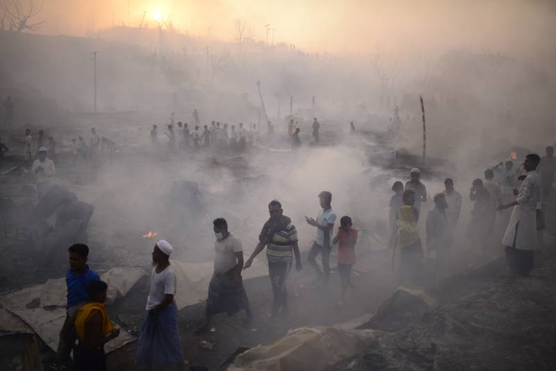 Rohingya refugees try to salvage their belongings after a major fire in their Balukhali camp at Ukhiya in Cox's Bazar, Bangladesh on March 5. AP