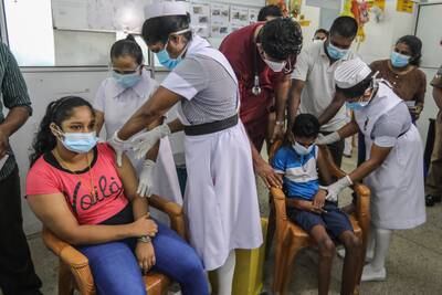 Hospital workers assisted by parents administer doses of Covid-19 vaccine to children at the Lady Ridgeway Children's Hospital in Colombo, Sri Lanka. EPA