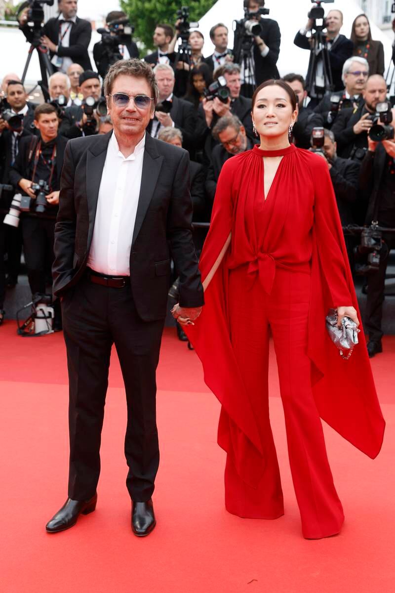 Gong Li wears red Elie Saab to attend the Indiana Jones and the Dial of Destiny premiere with Jean-Michel Jarre. EPA 
