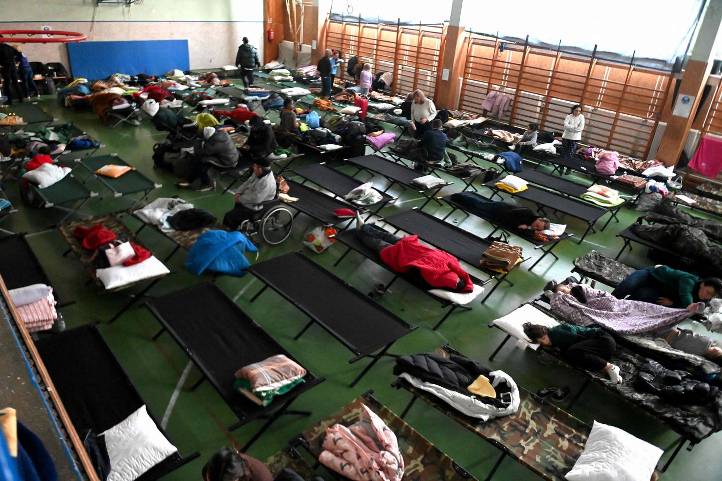 Refugees rest at a temporary reception centre at a school in Zahony, Hungary. AFP 