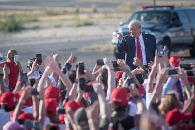 epa08758241 US President Donald Trump greets supporters at Tucson International Airport in Tucson, Arizona, USA, 19 October 2020. Arizona, which has been a traditionally Republican majority state, is in play in the 2020 US presidential election, with polls showing that challenger Joe Biden may win the state and Democratic Senate candidate Mark Kelly may complete the flip from republican to democrat in major political offices.  EPA/RICK D'ELIA