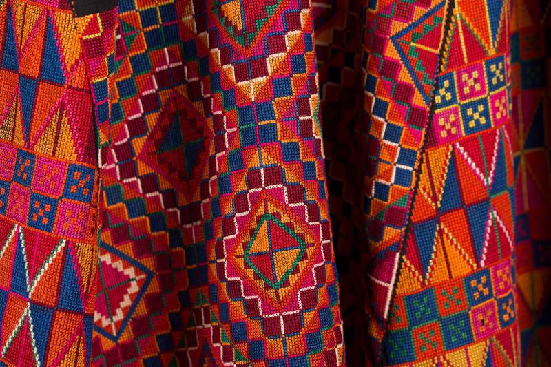 A detail of an embroidered dress. Kayane Antreassian / The Palestinian Museum