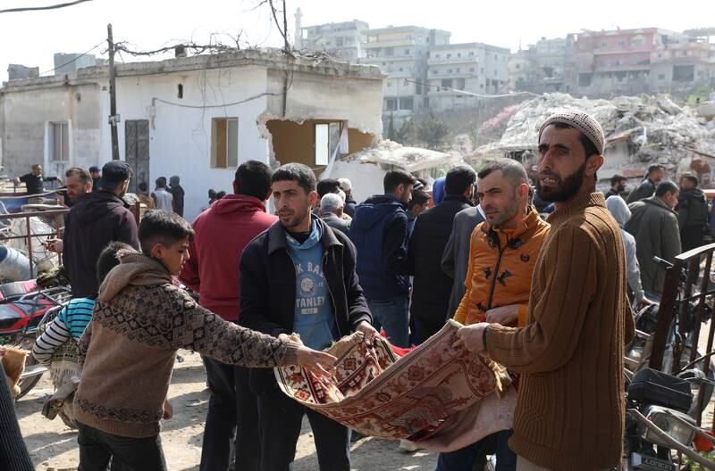 People collect donations for rebuilding a mosque in Maland, Idlib, after it collapsed in the earthquake. EPA