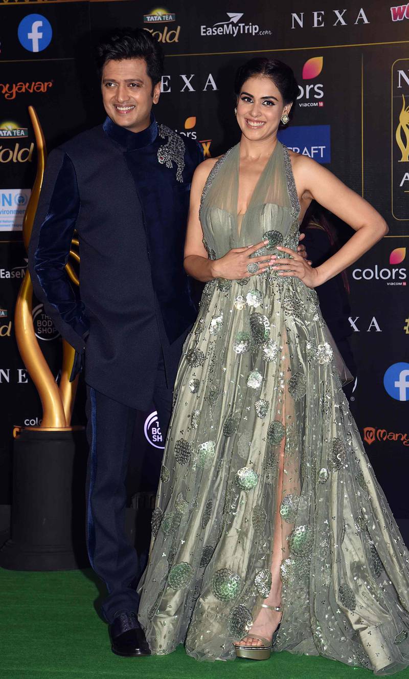 Married acting pair Ritesh Deshmukh and Genelia D'Souza arrive for the 20th International Indian Film Academy (IIFA) Awards at NSCI Dome in Mumbai on September 18, 2019. AFP