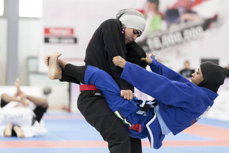 Maitha Harasi, black, fights Shamsa Hasan, during a Female Blue Adult 55KG match at Al Ain Jiu Jitsu Open Championship. Reem Mohammed / The National