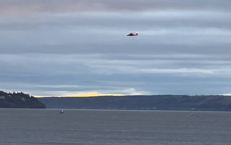 A US Coast Guard helicopter is flown near Whidbey Island, Washington, where a float plane crashed  on Sunday. AP